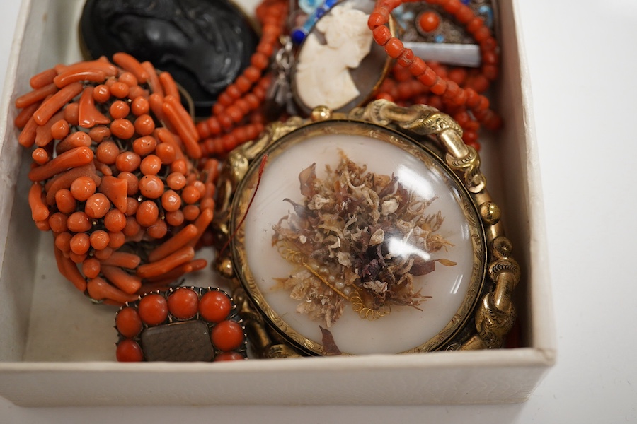 A Victorian yellow metal and coral bead set mourning brooch, with plaited hair beneath a glazed panel, 22mm, a filigree 925, coral and enamel set fan brooch and six other items including a coral branch and bead cluster b